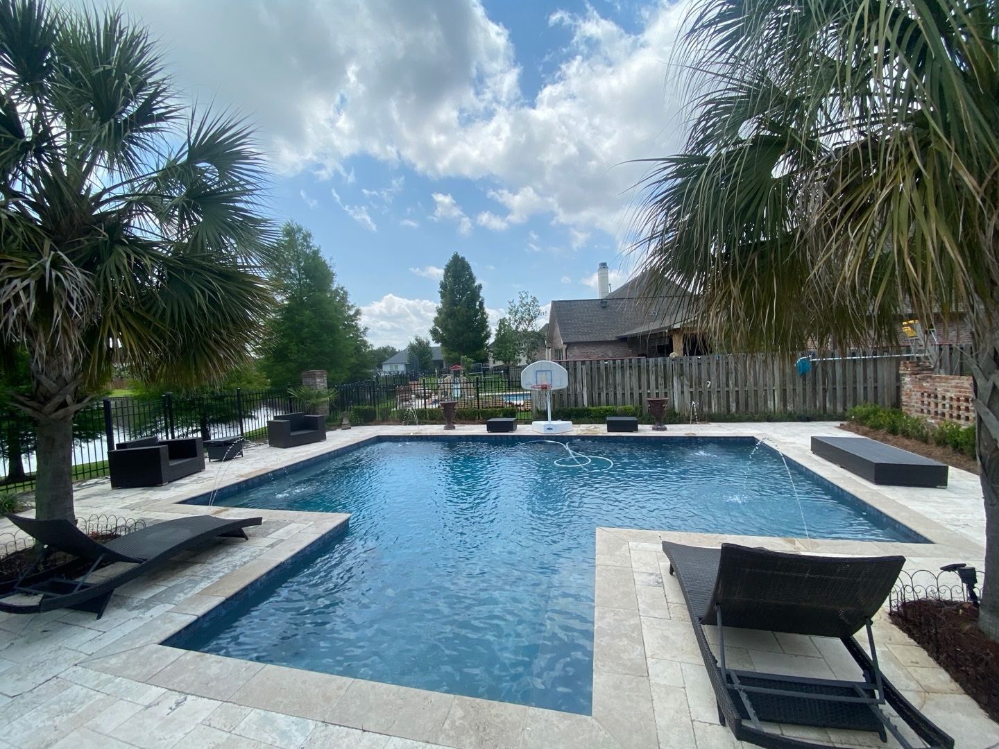 Featured travertine pool with deck jets, clear blue water