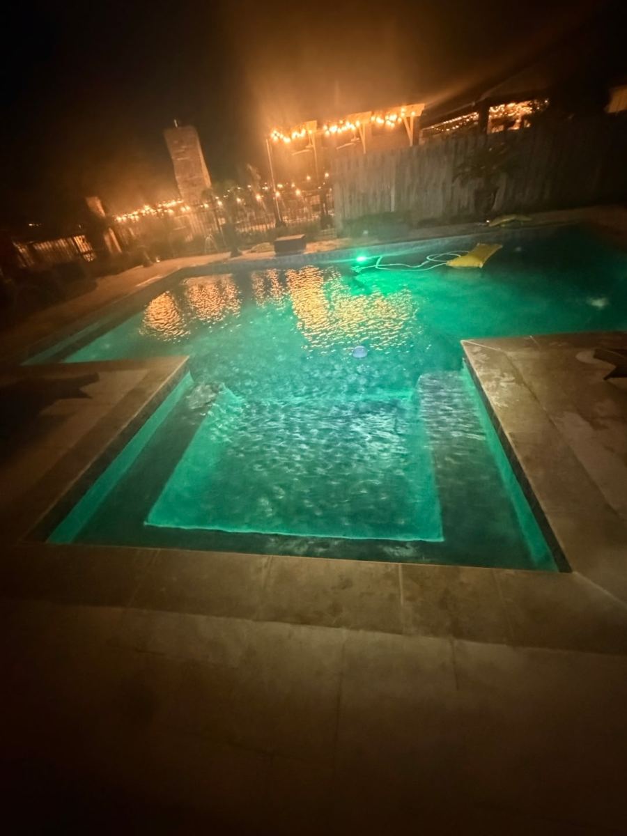 Featured pool lit green at night